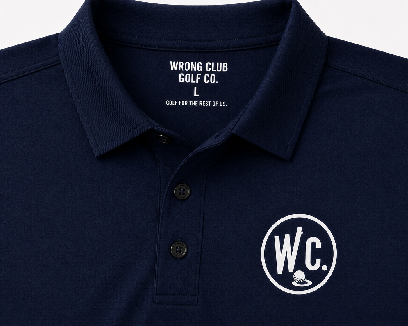 Close detail of the collar, placket, and chest crest on the navy Wrong Club Crest Polo